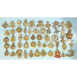 A collection of fifty-two various brass military badges, (52).