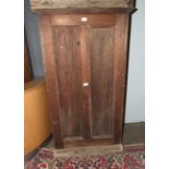 A stained wood freestanding cupboard, the panelled door opening to reveal four drawers, 75cm wide,