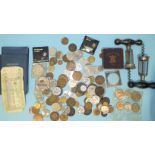 A small collection of mixed coinage and two corkscrews.