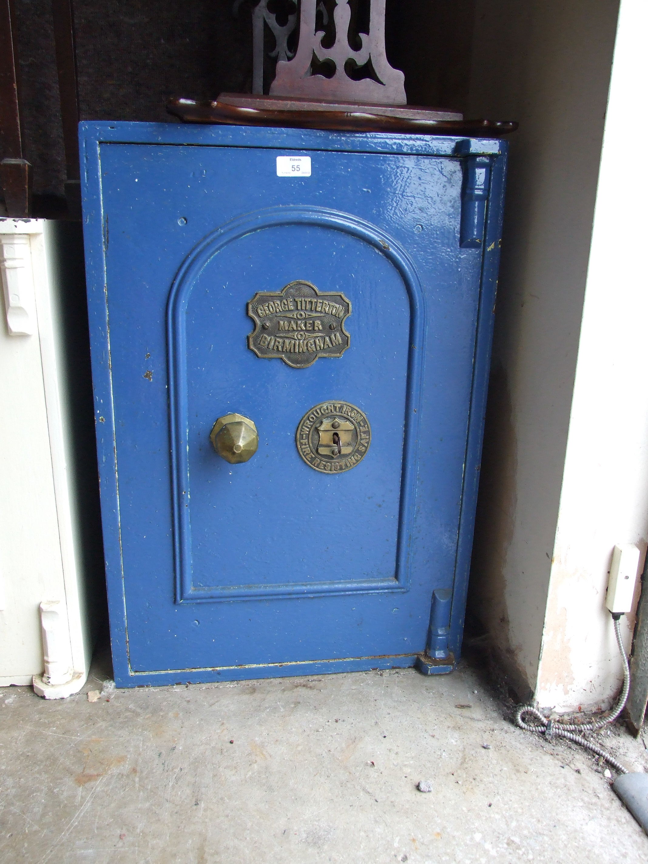 An iron safe by George Titterton, Birmingham, with key, 71cm high, 54cm internal.