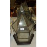 A hexagonal-shaped brass frame and glass terrarium, 46cm high and a smaller similar terrarium, (door