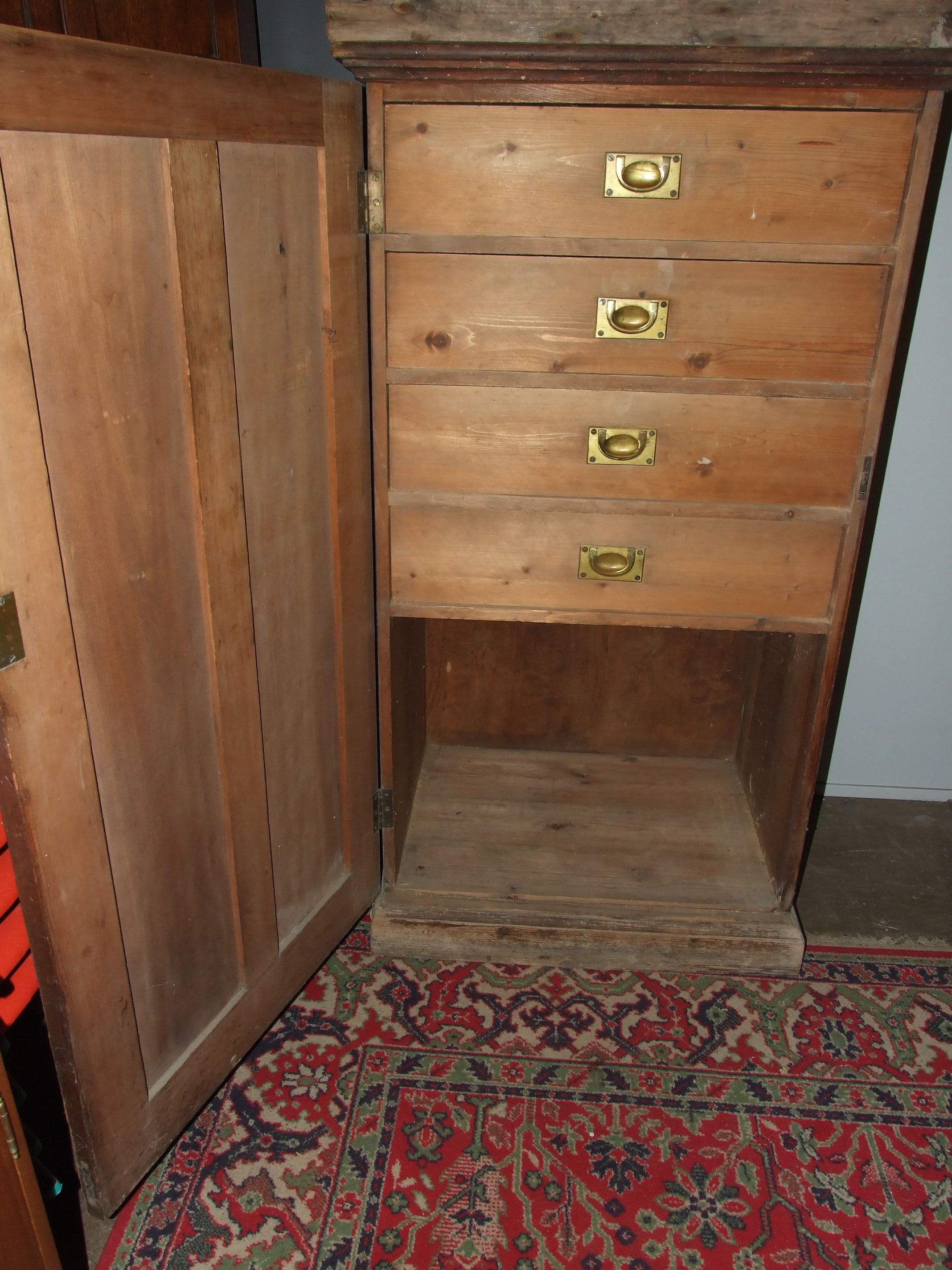 A stained wood freestanding cupboard, the panelled door opening to reveal four drawers, 75cm wide, - Image 2 of 3