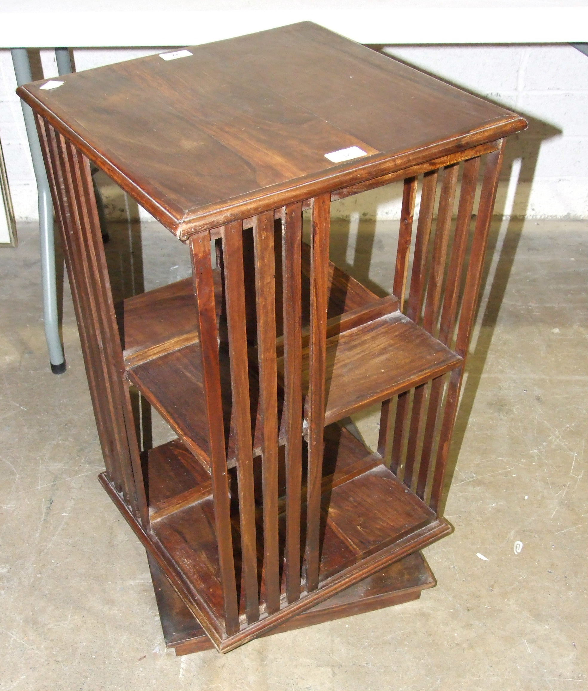 A stained wood revolving bookcase, the top 42cm square, 74cm high.