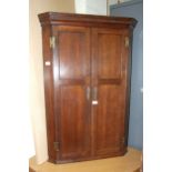 A Georgian oak corner cupboard with dentil cornice, 72cm wide, 108cm high.