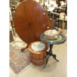 A mahogany oval tilt-top table, an ebonised circular table, a circular Victorian walnut commode