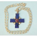 A silver-mounted lapis lazuli, ruby and pearl cross, 4cm x 4cm, on silver chain.