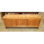 A retro hardwood low sideboard, with ceramic tiled top above three sliding panel doors, 190cm