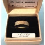 A 9ct gold ring with raised Chinese characters for fire, earth, metal, water and wood, size S, 2.
