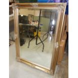 A modern gilt-painted framed wall mirror with bevelled plate, 75 x 108cm.