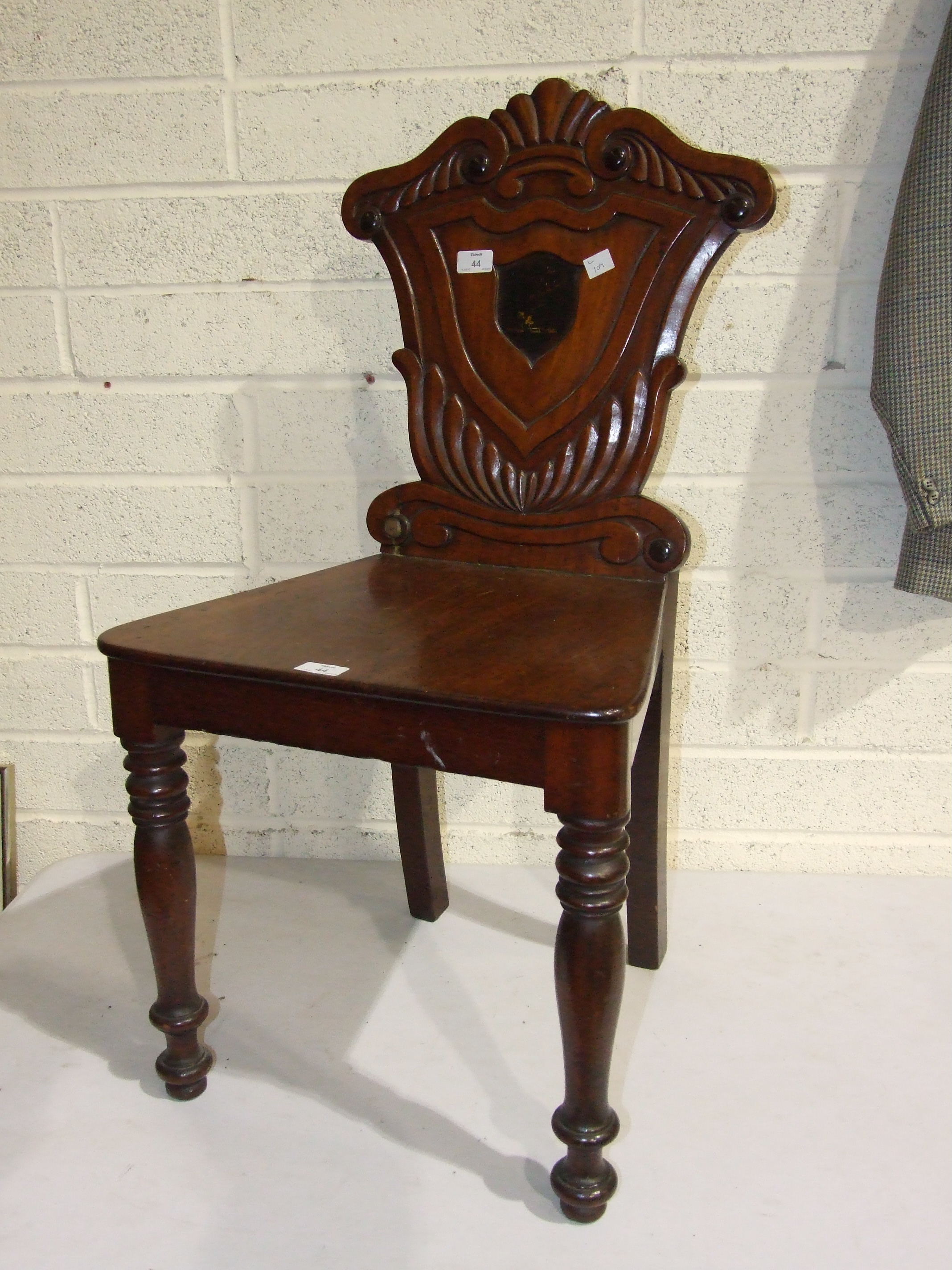 A Victorian mahogany hall chair, damaged and restored.