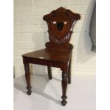 A Victorian mahogany hall chair, damaged and restored.
