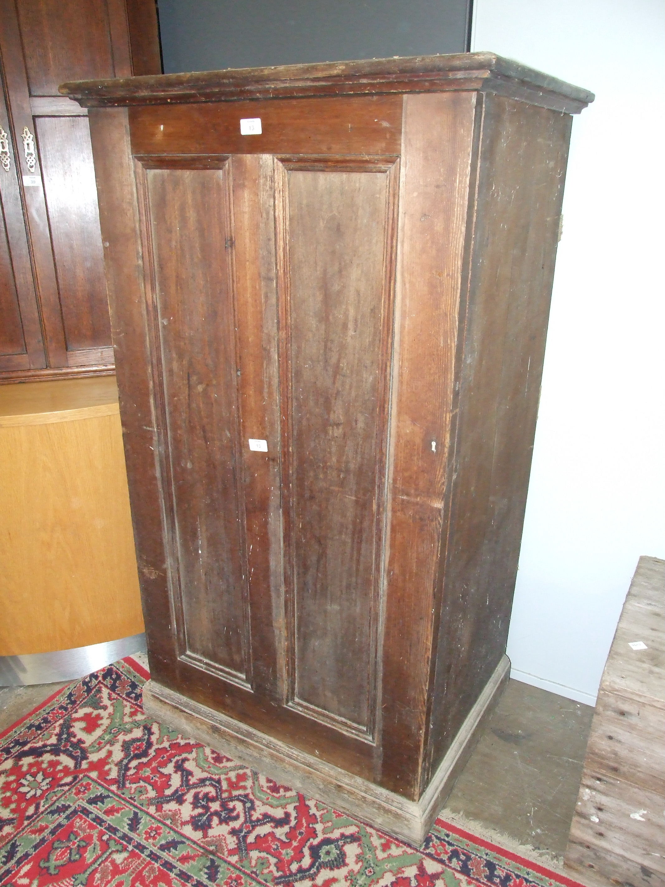 A stained wood freestanding cupboard, the panelled door opening to reveal four drawers, 75cm wide, - Image 3 of 3