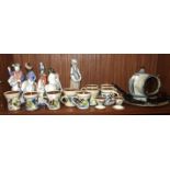 A collection of pottery coffee cups, egg cups marked 'PL', a Seth Cardew salt pig, a Lladro figure