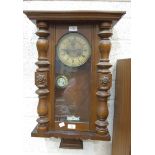 A wood-cased wall clock, 65cm high.
