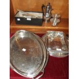 Two plated entrée dishes, a plated oval two-handled tray, a small collection of cutlery and other