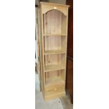 A modern narrow stripped pine bookcase, 50 x 184cm high.