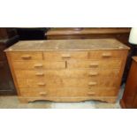 A veneered pine chest of five small and three long drawers, 154cm wide, 87cm high.