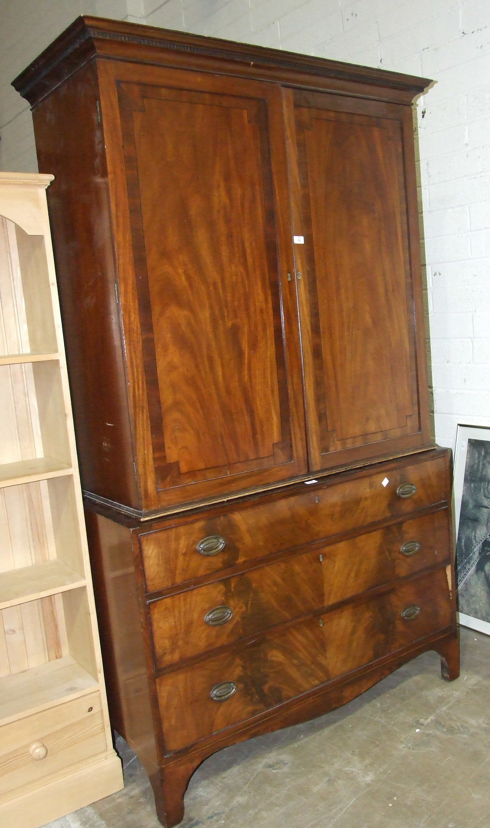 A Victorian mahogany chest of three long drawers and a linen press section, altered as a wardrobe,