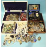 A quantity of costume jewellery in three jewellery boxes and a bag.