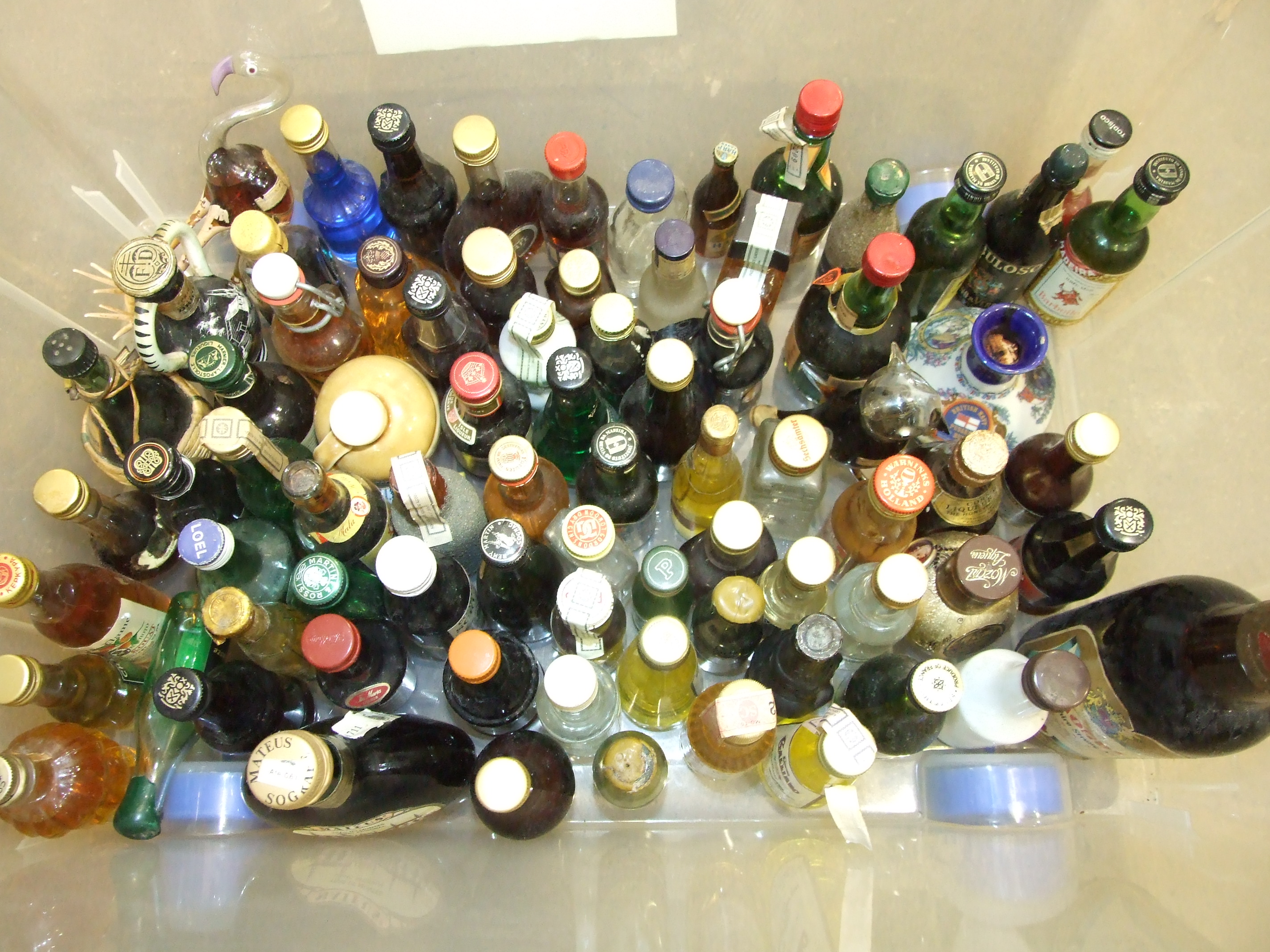 A collection of approximately eighty alcohol miniatures.