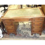 An Edwardian mahogany knee-hole desk, the rectangular top with inset above three frieze drawers