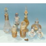 A silver-mounted cut-glass scent bottle with stopper, 19cm and seven other glass scent bottles, (