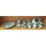 A collection of vintage pewter ware, including four plates, 23cm diameter, twelve tankards of