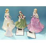 Three Royal Doulton figurines: 'Victoria' HN4623, boxed, 'Christmas Day' HN4757, both with