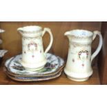 Two early-20th century milk jugs and two ironstone plates, (4).