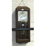 A 1920's oak-cased chiming wall clock, 78cm high.