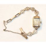 A lady's 9ct-gold-cased wrist watch on 9ct gold bracelet, (not working), gross weight 12.2g.