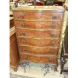 A mid-20th century walnut chest, the serpentine top above six long cockbeaded drawers, on scroll