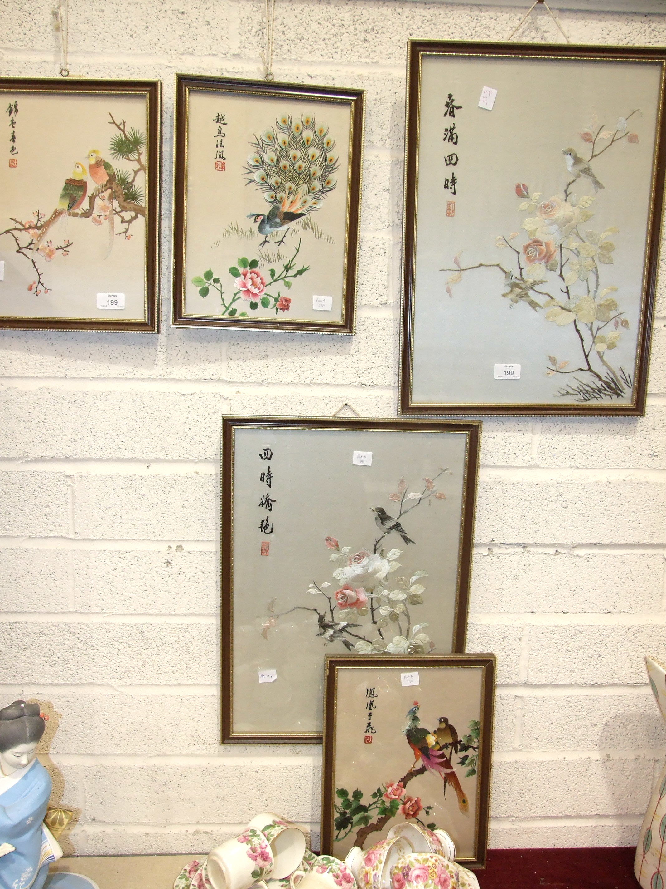 A collection of five 20th century Oriental silk-work pictures depicting birds.