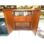 A mahogany medicine cabinet, the rectangular top above a pair of doors opening to reveal six drawers