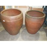 Two large glazed pottery planters of baluster shape, 66cm and 60cm high.