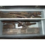 A collection of wooden planes and other tools, in three wooden tool boxes.