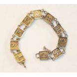 A bracelet of square plaque links, each with raised zodiac sign, 16.8g, unmarked.