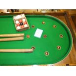 A Victorian mahogany folding bagatelle board with cues and balls, 214cm long, 56cm wide.