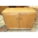 A small Ercol two-door sideboard, 91cm wide, 70cm high.