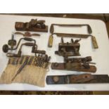 Two braces and a collection of auger bits, a wood, iron and brass plane and other tools.