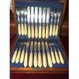 A set of twelve each ivory-handled dessert knives and forks by Mappin Brothers, in fitted mahogany