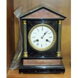 A black slate and marble striking mantel clock of architectural design, with brass pillars, 29.5cm