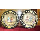 Two continental painted wall plates with blue and gilt surrounds depicting tavern interiors, 23cm