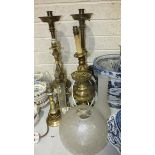 A pair of heavy brass loaded-base church candlesticks, 57cm high and other table lamps.