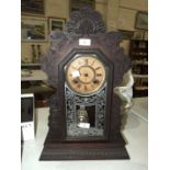 An Ansonia Clock Co. stained wood mantel clock, 57cm high, 37cm wide.
