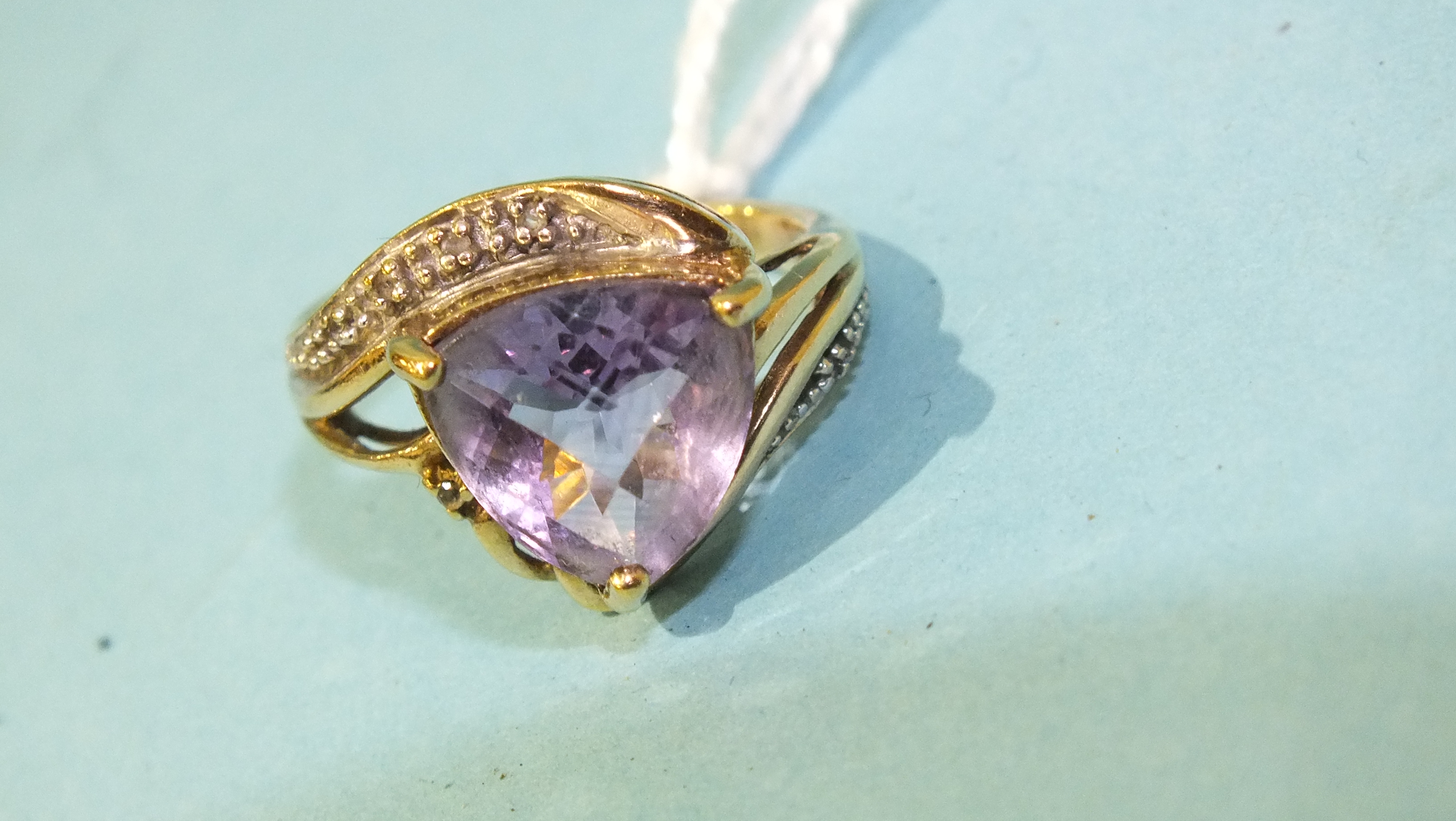 A 9ct gold ring set faceted triangular amethyst, size O, 4.2g.