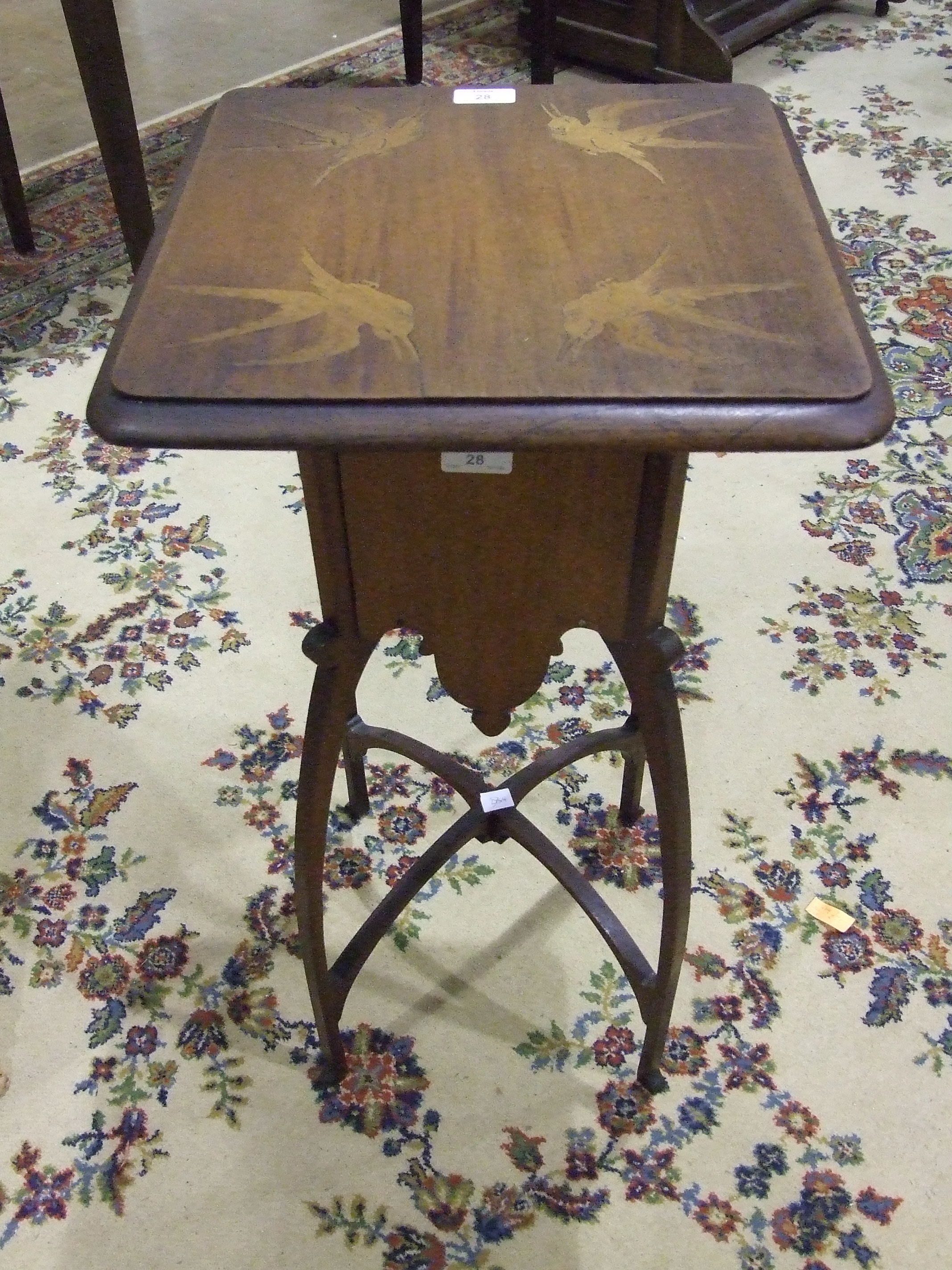 An Art Nouveau-style hardwood plant stand, the top inlaid with birds, on shaped legs and stretchers,