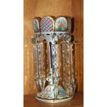 A Victorian overlay cranberry glass lustre decorated with painted floral panels, 29cm high.