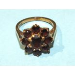 A garnet cluster ring claw-set nine garnets, in 9ct gold mount, size O, 4.1g.