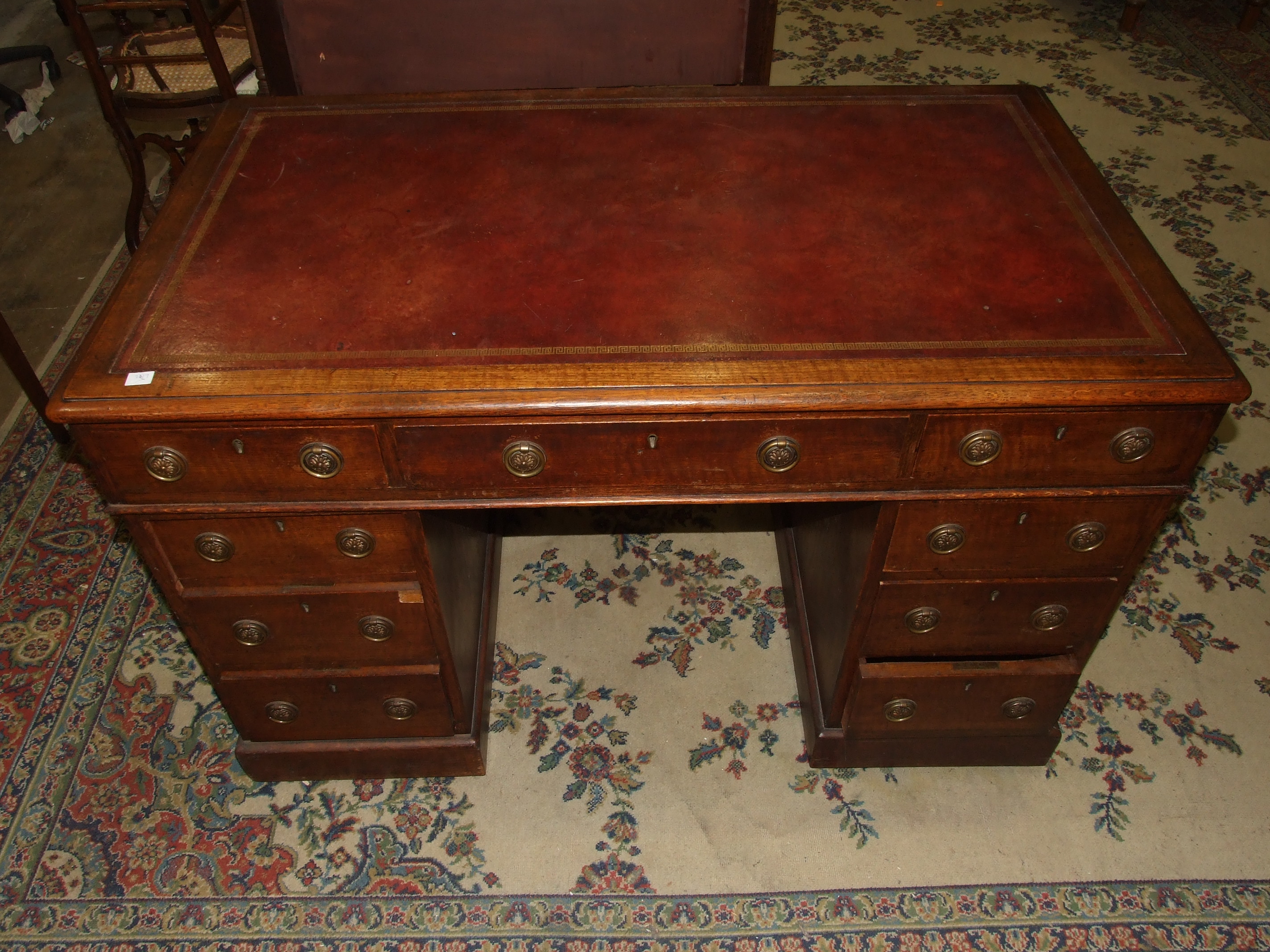 An Edwardian oak knee-hole desk, the top inset with writing surface above three frieze and six - Image 2 of 3